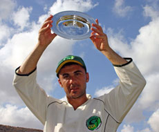 Cyprus captain Michael Kyriacou holds aloft the European Division Four Championship trophy after they won the competition on net run-rate on the final day.