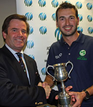 Ireland captain Ryan Haire receives the ICC Europe A Team trophy from Albert Van Nierop of the KNCB.