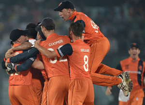 Dutch players celebrate the fall of the final wicket to complete their 45 runs victory over England.